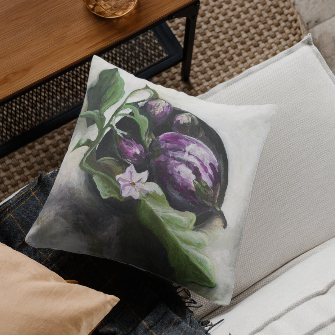 Decorative pillow with aubergine illustration on a couch