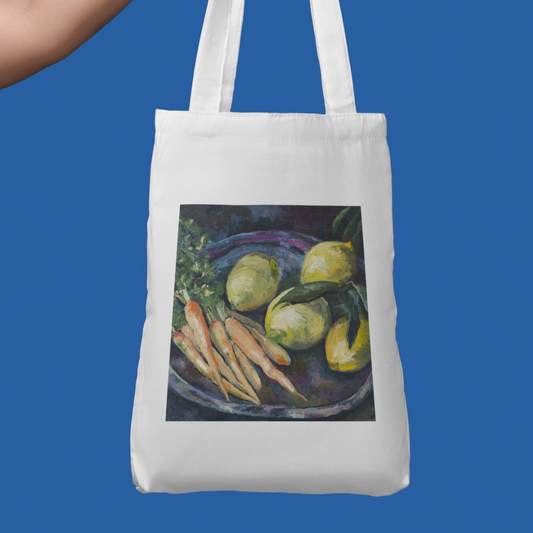 White tote bag with a painting of vegetables on a blue background